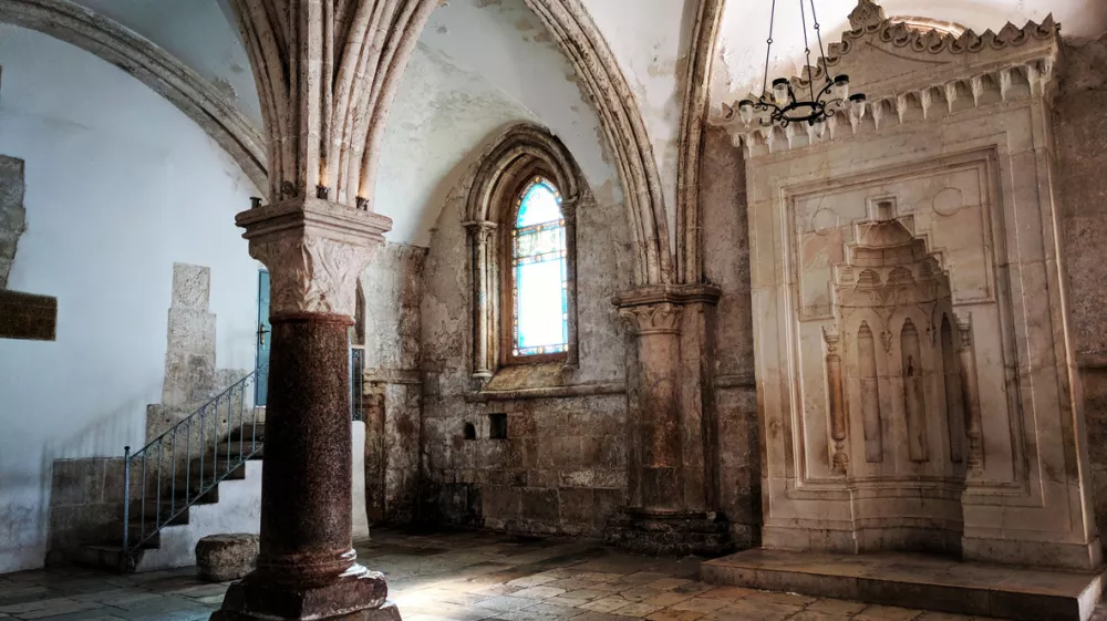 This is the Cenacle, also known as the Upper Room, a significant historical site on Mount Zion in Jerusalem, Middle East. Renowned for its Gothic-style architecture, this sacred space is traditionally believed to be the location of the Last Supper. The room holds immense spiritual importance for both Christians and Jews, making it a prominent religious landmark.