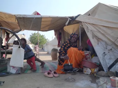Awadiya Al-Day Ibrahim prepares meal for her family with World Food Programme (WFP) food supplies at a tent, in Kassala, Sudan March 19, 2025, in this screengrab obtained from a video. WFP/Handout via REUTERS THIS IMAGE HAS BEEN SUPPLIED BY A THIRD PARTY