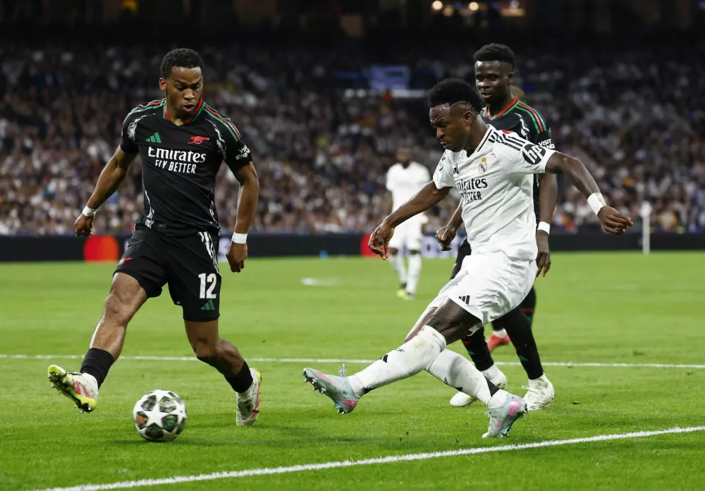 Soccer Football - Champions League - Quarter Final - Second Leg - Real Madrid v Arsenal - Santiago Bernabeu, Madrid, Spain - April 16, 2025 Real Madrid's Vinicius Junior in action with Arsenal's Jurrien Timber REUTERS/Juan Medina