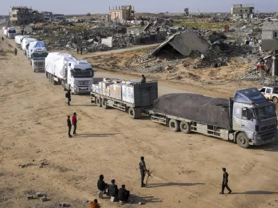Trucks carrying humanitarian aid enter the Gaza Strip from Egypt in the southern Gaza town of Rafah, Wednesday, Feb. 12, 2025.(AP Photo/Abdel Kareem Hana)
