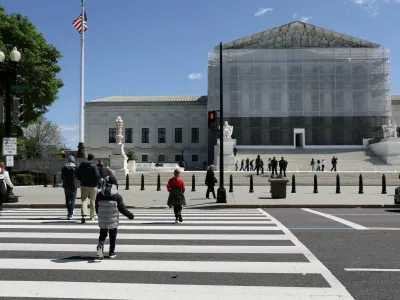 FILE PHOTO: People walk near the U.S. Supreme Court building in Washington, D.C., U.S., April 8, 2025. REUTERS/Jonathan Ernst/File Photo