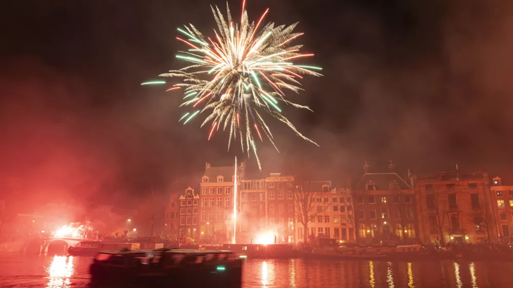 AJAX supporters celebrate the 125th anniversary of the football club. Thousands of fans of the historic Dutch FC travel and gather in Amsterdam, the Netherlands, on March 18, 2025, to march through the city and set up fireworks and flares while chanting their favorite slogans. The fans walk until the Amstel River where they set up a show with multiple fireworks lighting up the night sky of the capital. (Photo by Gene Medi/NurPhoto)NO USE FRANCE