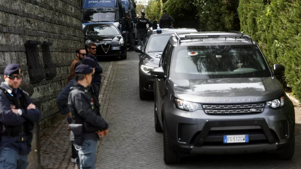 Police members stand as vehicles leave the Omani embassy, where the second round of U.S.-Iran talks is taking place, in Rome, Italy, April 19, 2025. REUTERS/Vincenzo Livieri