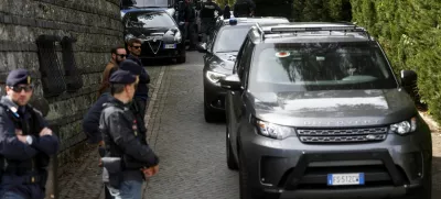 Police members stand as vehicles leave the Omani embassy, where the second round of U.S.-Iran talks is taking place, in Rome, Italy, April 19, 2025. REUTERS/Vincenzo Livieri