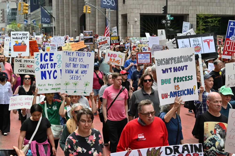 19 April 2025, US, New York: Protesters march through Midtown Manhattan to demonstrate against the Trump administration's policies on government, climate change, tariffs, immigration, and education. The organization 50501 places particular focus on condemning the administration's stance on immigration during the demonstration. Photo: Andrea Renault/ZUMA Press Wire/dpa