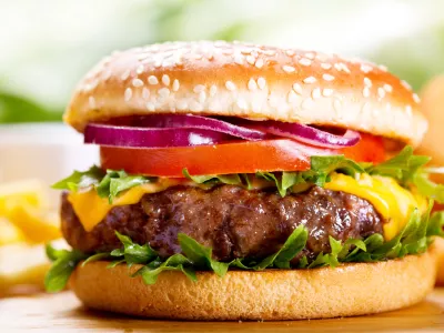 hamburger with fries on wooden table