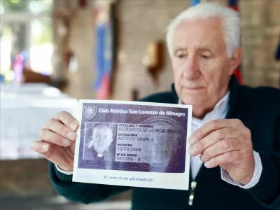 Oscar Lucchini, who is in charge of the chapel of San Lorenzo de Almagro, Pope Francis' hometown soccer team, holds an image of Francis' membership card following his death, in Buenos Aires, Argentina April 21, 2025. REUTERS/Matias Baglietto