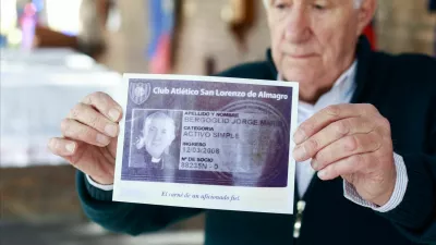 Oscar Lucchini, who is in charge of the chapel of San Lorenzo de Almagro, Pope Francis' hometown soccer team, holds an image of Francis' membership card following his death, in Buenos Aires, Argentina April 21, 2025. REUTERS/Matias Baglietto