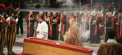 Cardinal Camerlengo Kevin Joseph Farrell, center right, spreads incense around the body of Pope Francis inside St. Peter's Basilica at the Vatican, Wednesday, April 23, 2025, where he will lie in state for three days. (AP Photo/Alessandra Tarantino)