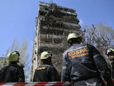 Rescue workers inspect a multi-storey building damaged by a Russian strike on residential neighbourhood in Zaporizhzhia, Ukraine, on Tuesday, April 22, 2025. (AP Photo/Kateryna Klochko)