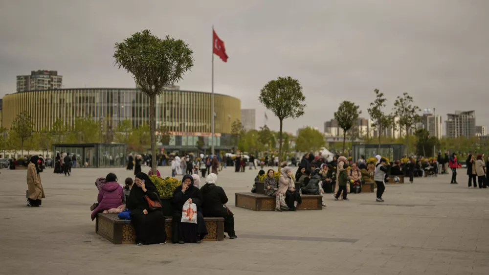 People gather outdoors following an earthquake shock with a preliminary magnitude of 6.2, in Istanbul, Turkey, Wednesday, April 23, 2025. (AP Photo/Khalil Hamra)