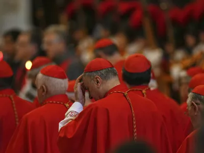 Cardinals stand by the body of Pope Francis, who will lie in state for three days, after it arrived in St. Peter's Basilica at the Vatican, Wednesday, April 23, 2025. (AP Photo/Francisco Seco)