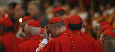 Cardinals stand by the body of Pope Francis, who will lie in state for three days, after it arrived in St. Peter's Basilica at the Vatican, Wednesday, April 23, 2025. (AP Photo/Francisco Seco)