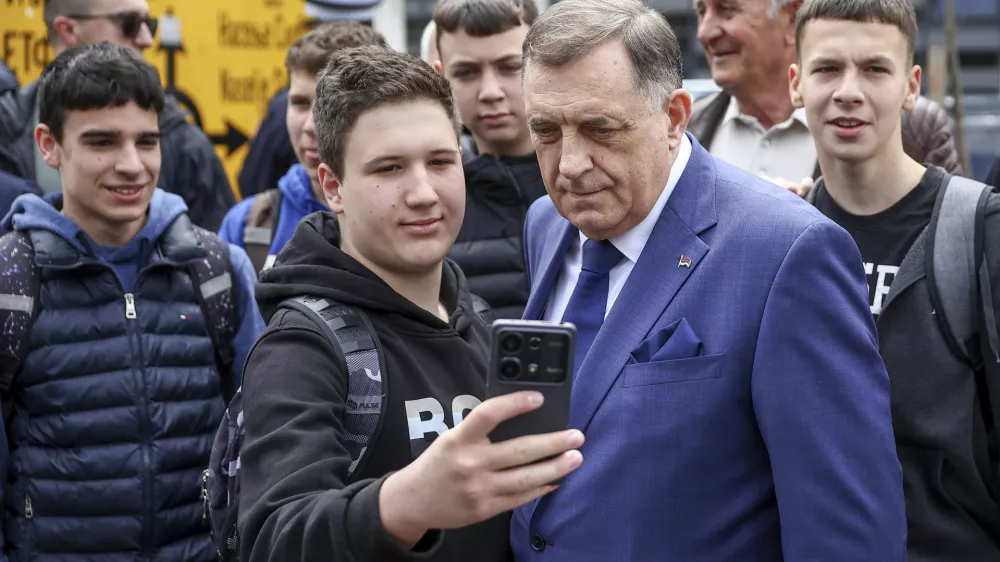 Bosnian Serb President Milorad Dodik, poses for a photo with his supporters at the opening ceremony of the rectory building in Istocno Sarajevo, Bosnia, Thursday, April 24, 2025. (AP Photo/Armin Durgut)