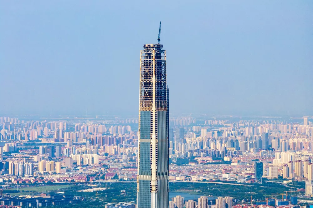 The 597-meter high Goldin Finance 117 Tower, known as the world's first unfinished building, is pictured in Tianjin, China, on August 28, 2024. The construction of Goldin Finance 117 Building in Xiqing District, Tianjin, begins in September 2008, and on September 8, 2015, Goldin Finance 117 completes the main structure. Goldin Finance 117 becomes an unfinished building, stalled by Goldin's plunging market value and poor sales. (Photo by Costfoto/NurPhoto via Getty Images)