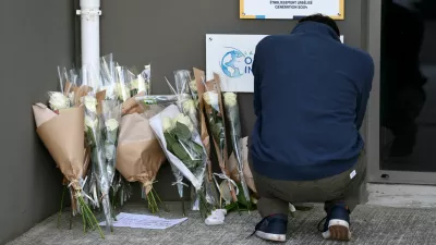 A man pays his respect next to flowers in front of the Notre-Dame-de-Toutes-Aides private school the day after one high school student was killed and three others injured in a stabbing attack by a 15-year-old boy, in Nantes, France, April 25, 2025. REUTERS/Stephane Mahe