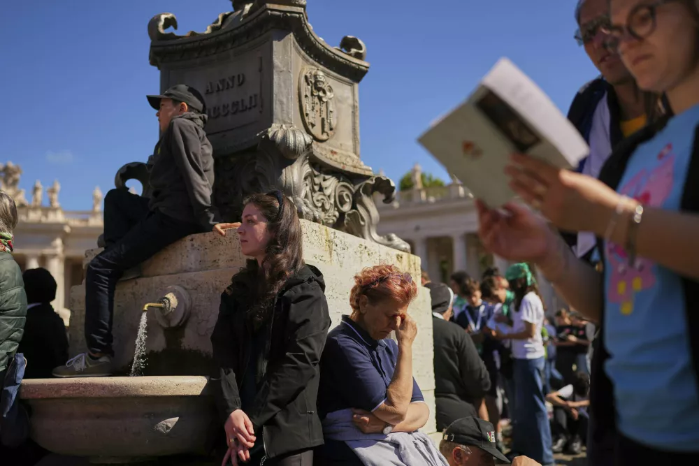 People attend the funeral of Pope Francis in St. Peter's Square at the Vatican, Saturday, April 26, 2025. (AP Photo/Andreea Alexandru)