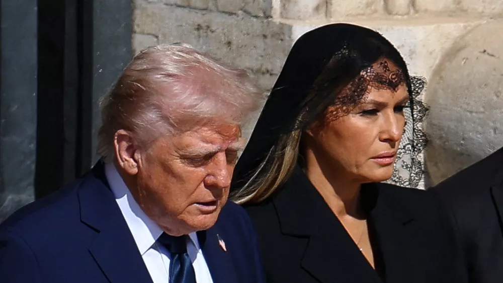 U.S President Donald Trump and first lady Melania Trump walk to attend the funeral Mass of Pope Francis, at the Vatican, April 26, 2025. REUTERS/Kai Pfaffenbach