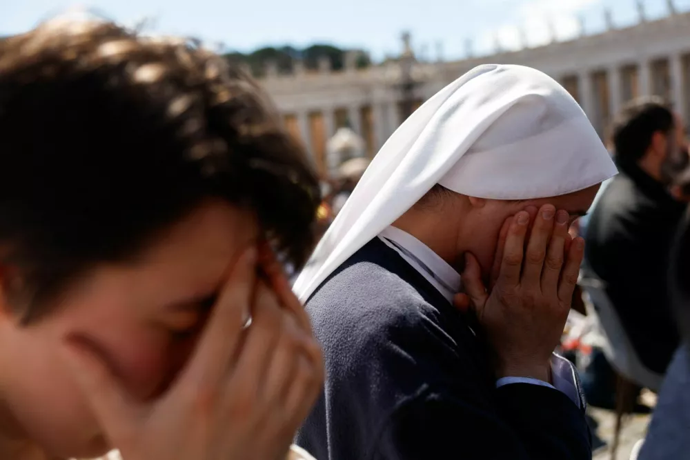 A nun prays during the funeral Mass of Pope Francis in St. Peter's Square at the Vatican, April 26, 2025. REUTERS/Susana Vera