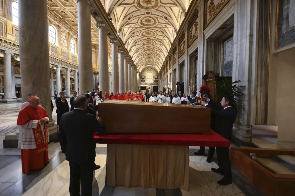 Cardinal Camerlengo Kevin Joseph Farrell, left, presides over the burial ceremony of late Pope Francis inside St. Mary Major Basilica in Rome Saturday, April 26, 2025. (Vatican Media via AP)
