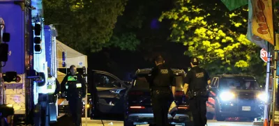 Police officers work by a SUV, which was driven into a crowd at the Lapu Lapu day block party, as bodies of victims lie covered on the ground, in Vancouver, Canada April 27, 2025. REUTERS/Chris Helgren