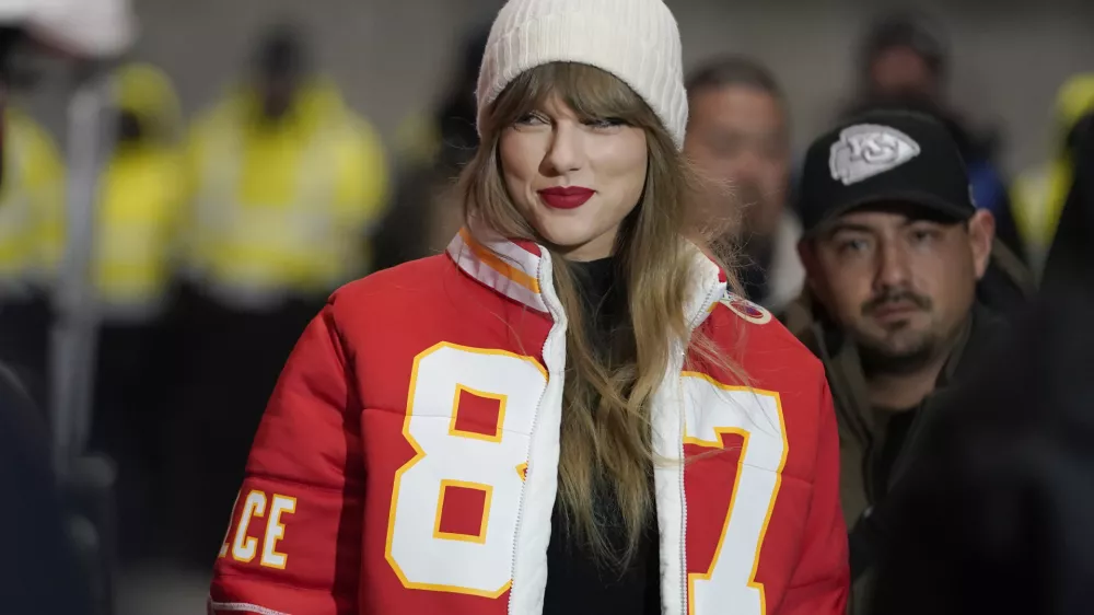 FILE - Taylor Swift wears a Kansas City Chiefs tight end Travis Kelce jacket as she arrives before an NFL wild-card playoff football game between the Chiefs and the Miami Dolphins, Saturday, Jan. 13, 2024, in Kansas City, Mo. A scourge of pornographic deepfake images generated by artificial intelligence and sexualizing people without their consent has hit its most famous victim, singer Taylor Swift, drawing attention to a problem that tech platforms and anti-abuse groups have struggled to solve. (AP Photo/Ed Zurga, File)