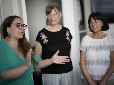 Lawyer Laura Sgro', left, talks to Mirjam Kovac, center, and Gloria Branciani, as they arrive for an interview with the Associated Press, in Rome, Friday, June 28, 2024. Kovac and Branciani are two of five women who urged Catholic bishops around the world to remove from their churches mosaics by ex-Jesuit artist Rev. Marko Rupnik after they accused him of psychologically, spiritually and sexually abusing them. (AP Photo/Andrew Medichini)