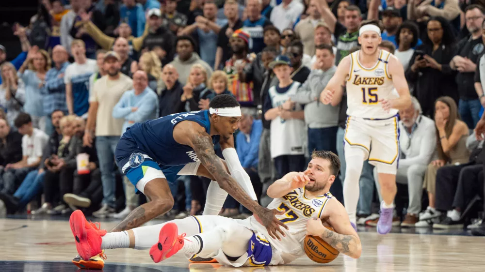 Apr 27, 2025; Minneapolis, Minnesota, USA; Los Angeles Lakers guard Luka Doncic (77) calls a timeout after stumbling on the defense of Minnesota Timberwolves forward Jaden McDaniels (3) in the fourth quarter during game four of first round for the 2025 NBA Playoffs at Target Center. Mandatory Credit: Matt Blewett-Imagn Images