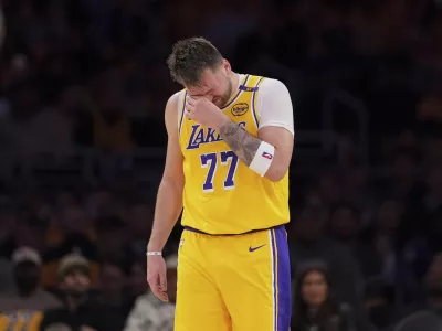 Los Angeles Lakers guard Luka Doncic wipes his face during the second half of an NBA basketball game against the Utah Jazz, Monday, Feb. 10, 2025, in Los Angeles. (AP Photo/Mark J. Terrill)