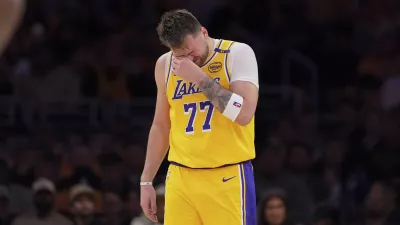 Los Angeles Lakers guard Luka Doncic wipes his face during the second half of an NBA basketball game against the Utah Jazz, Monday, Feb. 10, 2025, in Los Angeles. (AP Photo/Mark J. Terrill)