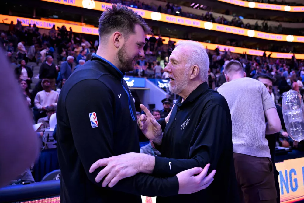 Feb 23, 2023; Dallas, Texas, USA; Dallas Mavericks guard Luka Doncic (left) talks with San Antonio Spurs head coach Gregg Popovich (right) after the game at the American Airlines Center. Mandatory Credit: Jerome Miron-USA TODAY Sports