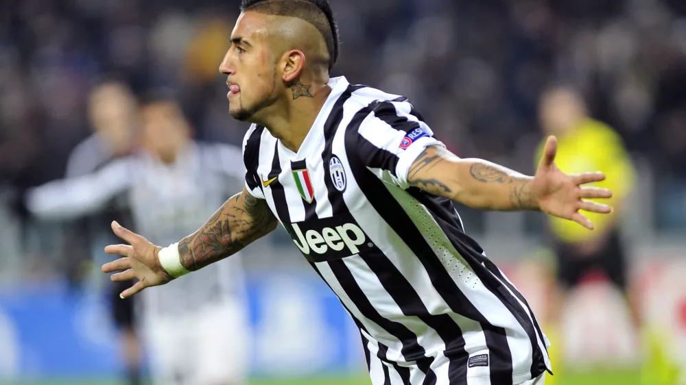 Juventus midfielder Arturo Vidal celebrates after scoring during the Champions League, Group B, soccer match between Juventus and Copenaghen at the Juventus stadium, in Turin, Italy, Wednesday, Nov. 27, 2013. Juventus won 3-1 and Vidal scored an hat-trick. (AP Photo/Massimo Pinca)