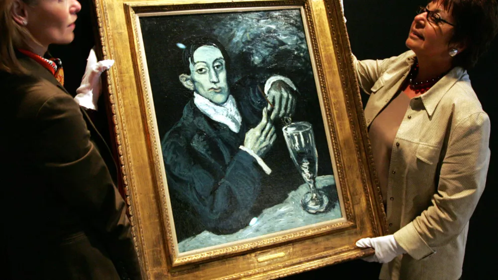 ** FILE ** In a file photo art experts (no names given) from Christie's display the blue period portrait of Angel Fernandez de Soto, 1903, by Pablo Picasso at the Roman-Germanic Museum in Cologne, western Germany, on Wednesday, Sept. 20, 2006. U.S. District Judge Jed S. Rakoff issued an order Monday, Nov. 6, 2006, temporarily blocking the  auction of the painting.  (AP Photo/Hermann J. Knippertz)