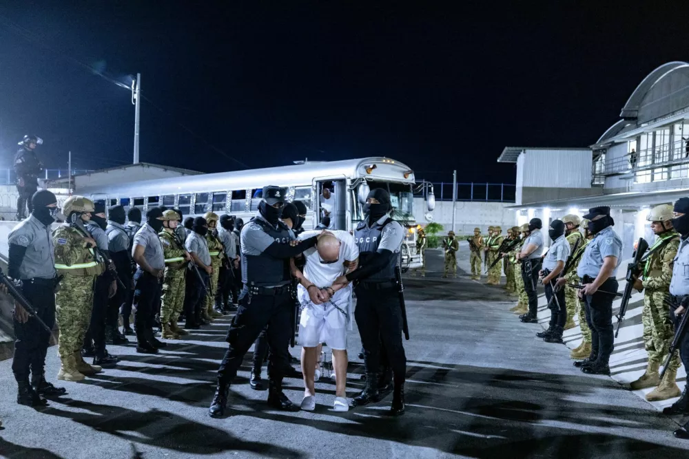 Salvadoran prison guards escort alleged members of the Venezuelan gang Tren de Aragua and the MS-13 gang recently deported by the U.S. government to be imprisoned in the Terrorism Confinement Center (CECOT) prison, as part of an agreement with the Salvadoran government, in Tecoluca, El Salvador, in this handout image obtained March 31, 2025. Secretaria de Prensa de la Presidencia/Handout via REUTERS ATTENTION EDITORS - THIS IMAGE HAS BEEN SUPPLIED BY A THIRD PARTY. NO RESALES. NO ARCHIVES