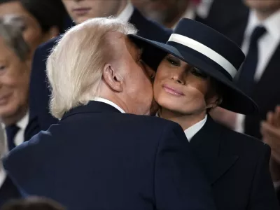 President Donald Trump kisses first lady Melania Trump during the 60th Presidential Inauguration in the Rotunda of the U.S. Capitol in Washington, Monday, Jan. 20, 2025. (AP Photo/Julia Demaree Nikhinson, Pool)