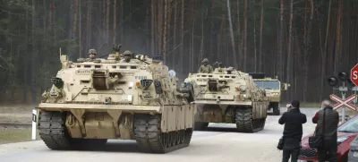 U.S. Army military vehicles including two M88 Recovery vehicles roll to attend recovery efforts continue for a missed U.S. Army soldier, as three other found dead on Monday, at a training range in Pabrade, north of Vilnius, Lithuania, Tuesday, April 1, 2025. (AP Photo/Mindaugas Kulbis)