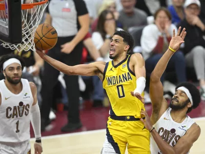 May 6, 2025; Cleveland, Ohio, USA; Indiana Pacers guard Tyrese Haliburton (0) drives to the basket between guard Max Strus (1) and center Jarrett Allen (31) in the fourth quarter during game two of the second round of the 2025 NBA Playoffs at Rocket Arena. Mandatory Credit: David Richard-Imagn Images
