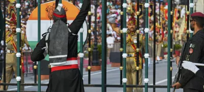 Pakistan's Rangers soldier, in black, and Indian Border Security Forces soldier, gesture to each other during a daily closing ceremony at the Wagah, a joint post on the Pakistan and India border, near Lahore, Pakistan, Saturday, May 3, 2025. (AP Photo/K.M. Chaudary)