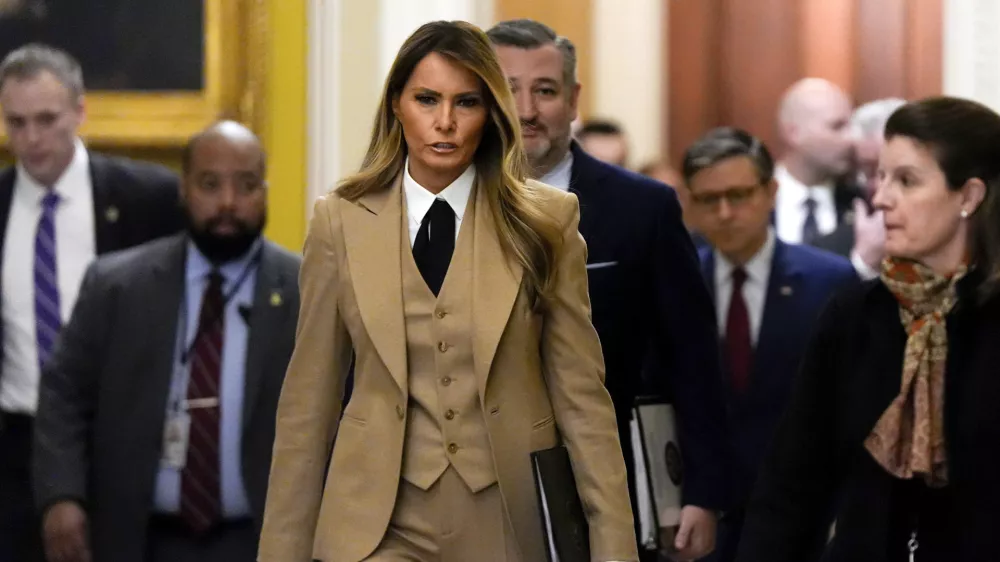 First lady Melania Trump, from center to right, followed by Sen. Ted Cruz, R-Texas, and House Speaker Mike Johnson, R-La., walks through the Capitol, Monday, March 3, 2025, in Washington. (AP Photo/Julia Demaree Nikhinson)