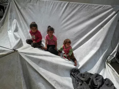Palestinian children sit on a tent as they are displaced by the Israeli military offensive, in Gaza City, May 1, 2025. REUTERS/Mahmoud Issa   TPX IMAGES OF THE DAY