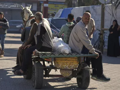 Relatives transport the body of a man killed in an overnight Israeli airstrike on a UN school, using a horse cart for burial in Deir al-Balah, in the central Gaza Strip, Wednesday, May 7, 2025. (AP Photo/Abdel Kareem Hana)