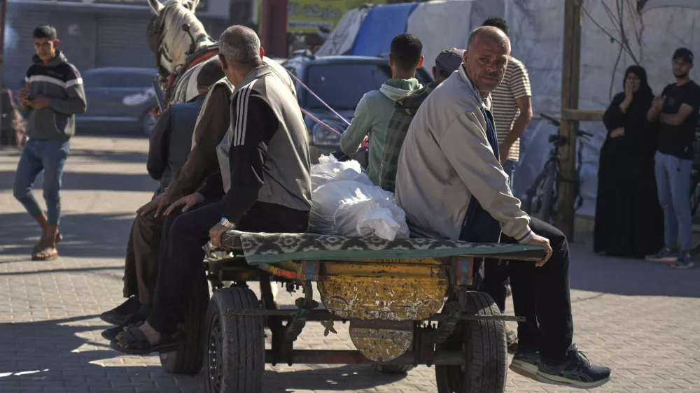 Relatives transport the body of a man killed in an overnight Israeli airstrike on a UN school, using a horse cart for burial in Deir al-Balah, in the central Gaza Strip, Wednesday, May 7, 2025. (AP Photo/Abdel Kareem Hana)