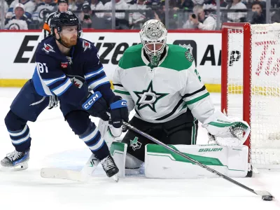 May 9, 2025; Winnipeg, Manitoba, CAN; Winnipeg Jets left wing Kyle Connor (81) stretches for the puck in front of Dallas Stars goaltender Jake Oettinger (29) in the second period in game two of the second round of the 2025 Stanley Cup Playoffs at Canada Life Centre. Mandatory Credit: James Carey Lauder-Imagn Images