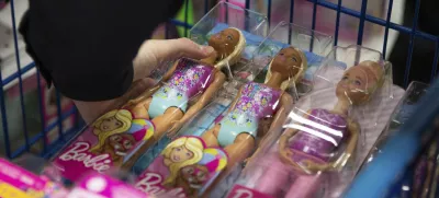 A collection of Barbie dolls are placed into a cart in Bowling Green, Ky., on Tuesday, Dec. 7, 2021. (Grace Ramey/Daily News via AP, File)