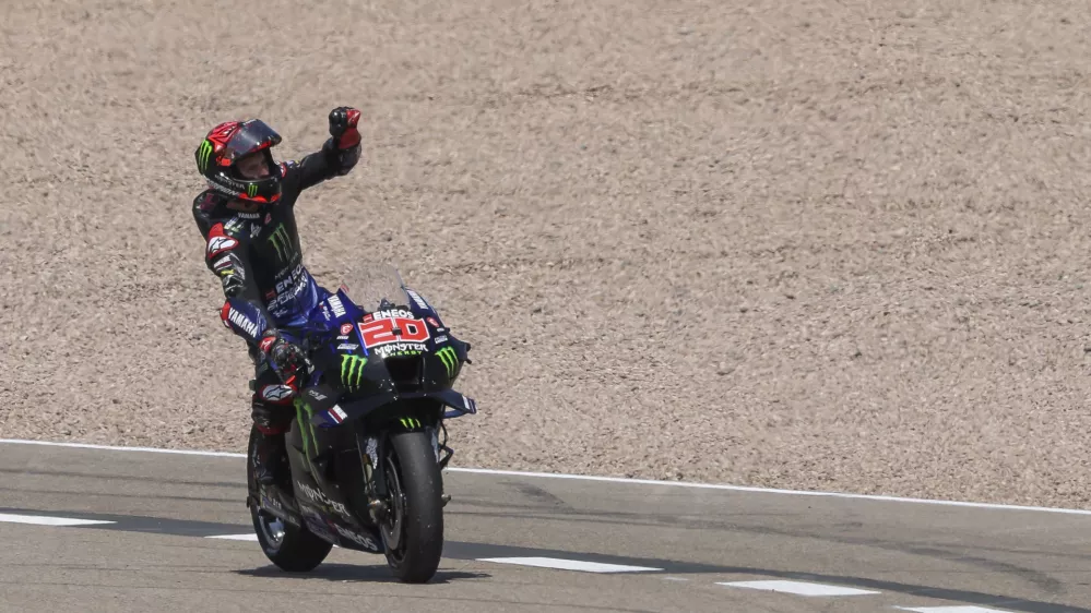 19 June 2022, Saxony, Hohenstein-Ernstthal: French rider Fabio Quartararo of the Monster Energy Yamaha MotoGP Team celebrates winning the MotoGP of Germany at the Sachsenring racing track. Photo: Jan Woitas/dpa
