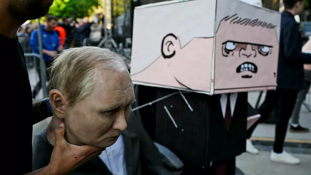 A puppet depicting Russian President Vladimir Putin and a figure with a box painted with a cartoon depicting Slovakian Prime Minister Robert Fico are prepared for an art performance held during an anti-government protest, in Bratislava, Slovakia, May 9, 2025. REUTERS/Radovan Stoklasa