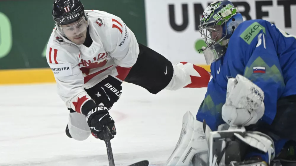 Canada's Travis Konecny and Slovenia's goal keeper Lukas Horak during the IIHF Ice Hockey World Championship group A match between Slovenia and Canada at Avicii Arena in Stockholm, Sweden, Saturday May 10, 2025. (Fredrik Sandberg/TT News Agency via AP)