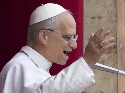 Pope Leo XIV speaks from the central balcony of St. Peter's Basilica from where he delivered his first Sunday blessing since his election to the faithful gathered in St. Peter's Square for the traditional Regina Caeli prayer at noon, on Sunday, May 11, 2025. (AP Photo/Domenico Stinellis)