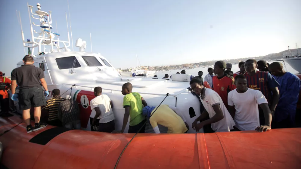 Migrants prepare to disembark in the island of Lampedusa, Italy, Wednesday, Aug. 7, 2013, after being rescued at sea by the Italian Coast Guard. Thousands of migrants heading to Europe arrive in Malta and Italy each year, often aboard unseaworthy boats. The Italian government has agreed to accept 102 migrants rescued at sea by a tanker that has been denied entry to Malta for two days. (AP Photo/Francesco Malavolta)