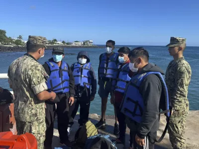 This government handout photo shows five shipwrecked fishermen wearing lifejackets, who were rescued by an Ecuadorian tuna fishing boat after being adrift for more than 50 days, at the San Cristobal Naval Base, Galapagos Islands, Ecuador, Saturday, May 10, 2025. (Ecuadorean Navy via AP)